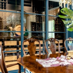 36 - Modern Wine Cellar With Black Out Window Beside Dining Area in San Diego Modern Wine Cellar in San Diego
