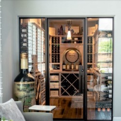 Custom contemporary wine cellar within a dining room.